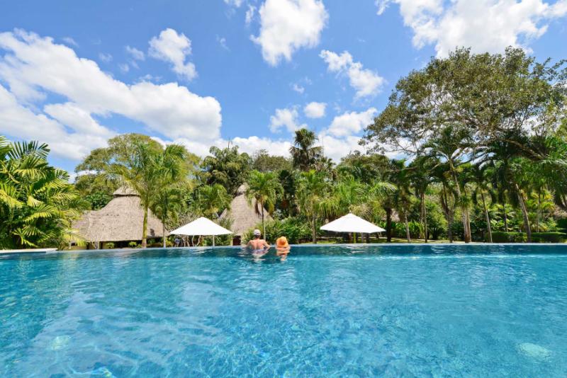People enjoying the infinity pool at Chaa Creek in Belize. Photo courtesy of Chaa Creek.