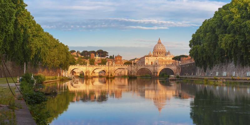 St. Peter's Basilica in the background with its reflection in the Tiber River in the foreground