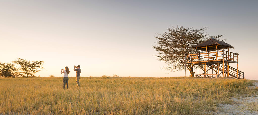 Couple on safari in the Makgadikgadi Pan, Botswana, Africa Couple on safari in the Makgadikgadi Pan, Botswana, Africa