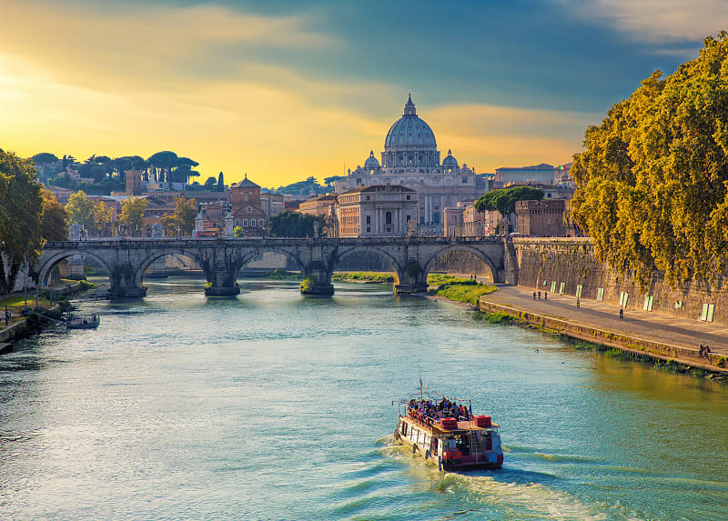 Boat sailing on Tiber River with Saint Peter's Basilica in Rome, Italy Boat sailing on Tiber River with Saint Peter's Basilica in Rome, Italy