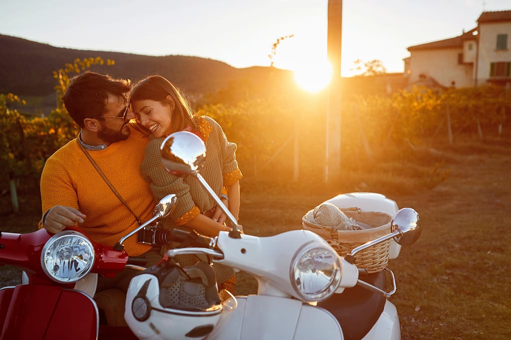 A young couple shares an embrace at a vineyard in Italy. A young couple shares an embrace at a vineyard in Italy.