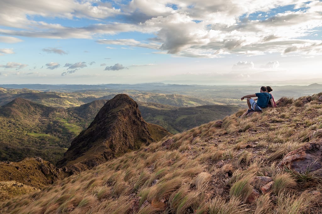 Couple enjoying views of Guanacaste, Costa Rica from the top of Pelado Hill Couple enjoying views of Guanacaste, Costa Rica from the top of Pelado Hill