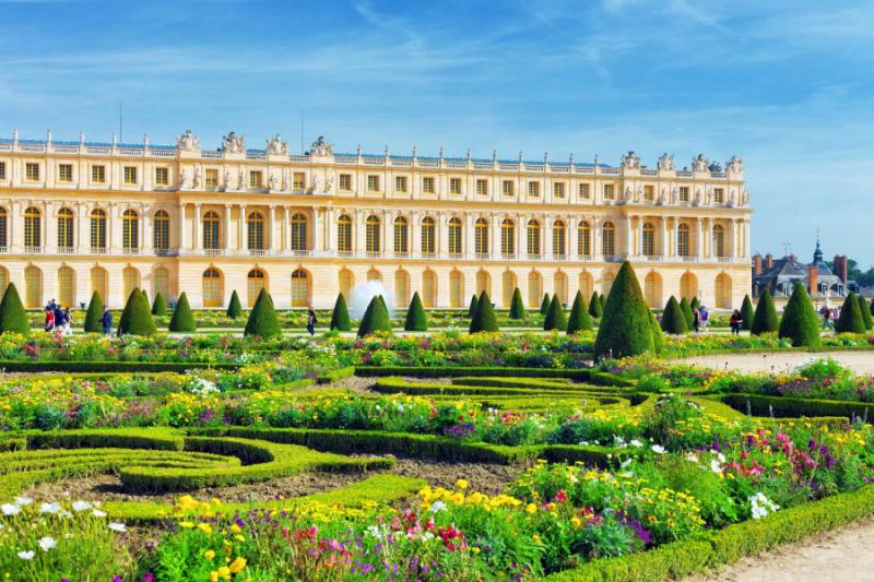 the lush green garden and building of versailles