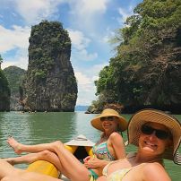Travelers kayaking through stone formations in Asia