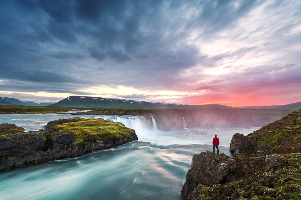 Godafoss waterfall in northern Iceland Man overlooking Godafoss waterfall in northern Iceland